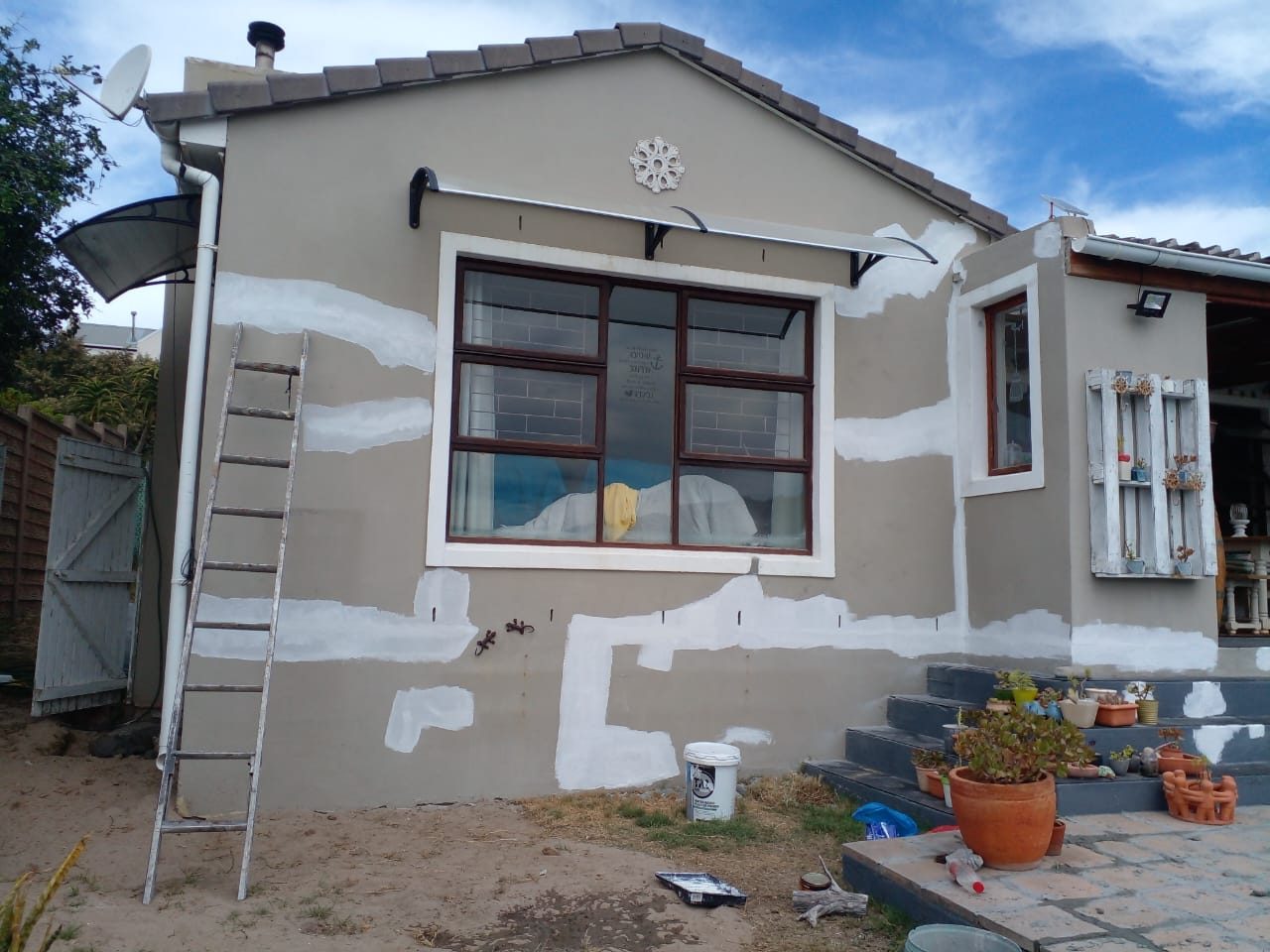 Exterior wall crack repair and surface preparation before painting