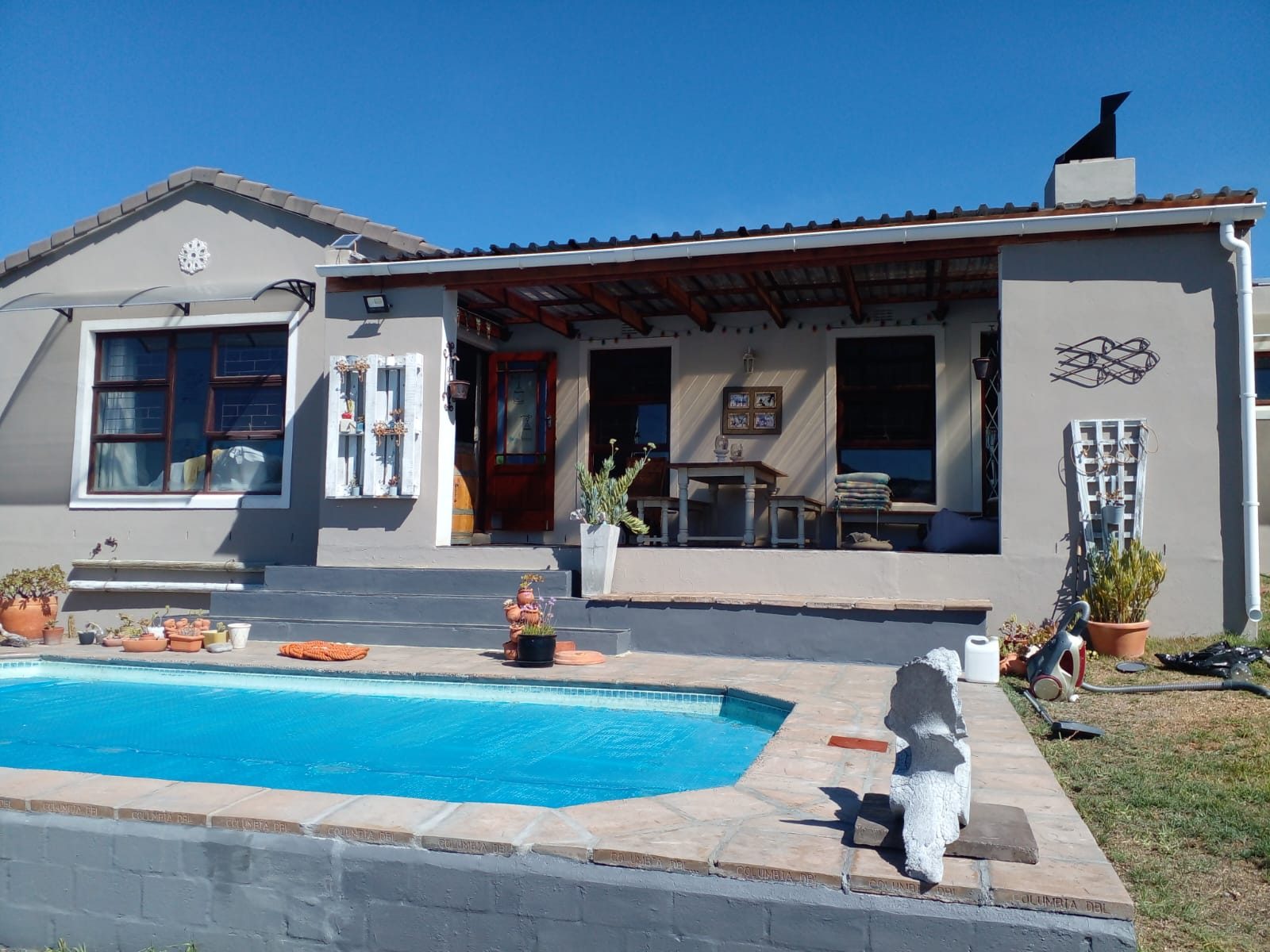 Finished pool, patio and painted cottage exterior in Cape Town