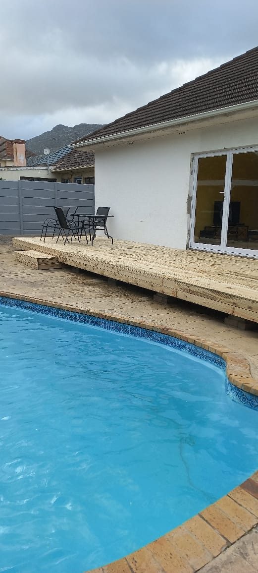 Timber pool deck alongside a swimming pool at a Cape Town home