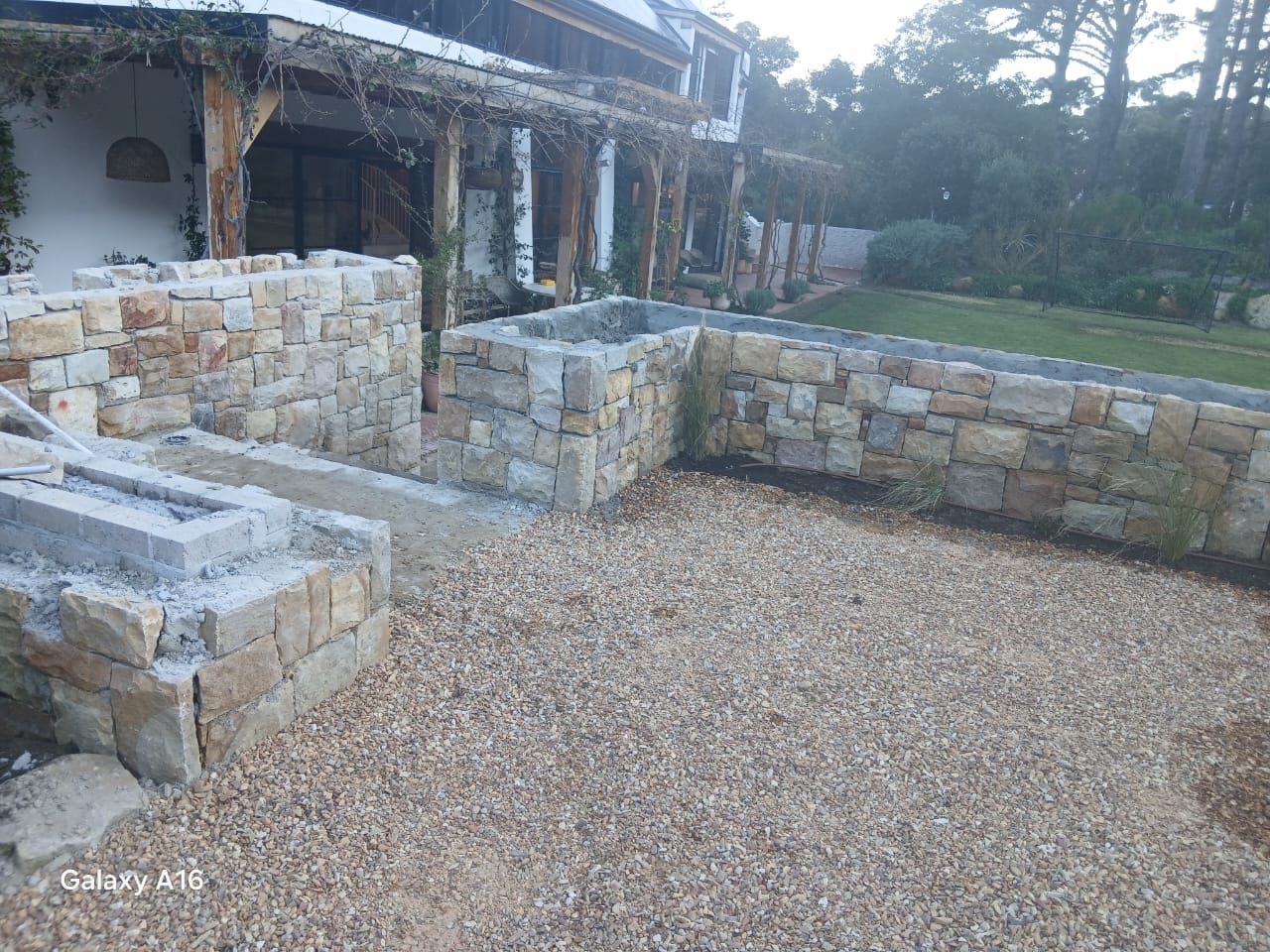 Natural stone garden walls and landscaped courtyard completed by Cape Crest Construction in Cape Town
